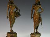 pair of bronze figurines of a woman and a man