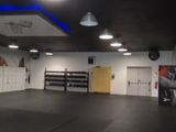 a large room with a black floor and a yellow door