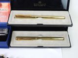two pens in a box and a pen in a case