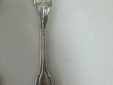 two spoons and a fork sitting on a table