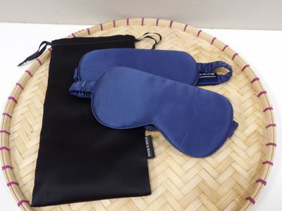 two pairs of eye masks and a pouch on a tray