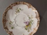a plate with a floral design on it sitting on a table