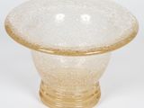 a glass bowl with a gold rim on a white background