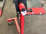 a picture of a red machine in a garage