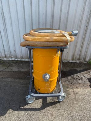 a yellow drum with a hose attached to it
