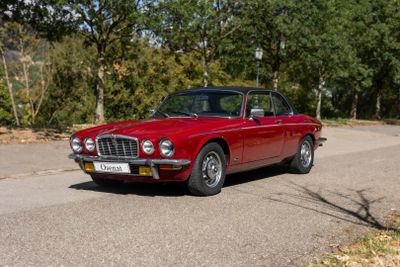 une voiture rouge garée sur le bord de la route