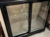 an image of a glass door refrigerator in a kitchen