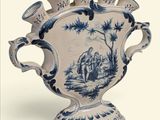 un vase bleu et blanc posé sur une surface blanche