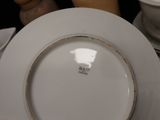 a white plate with a brown rim sitting on a table