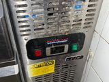 a machine that is sitting in the corner of a kitchen