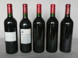 three bottles of wine sit next to each other on a table