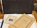 an open book sitting on top of a wooden table next to a chair