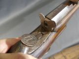 a person holding a gun in their hand on a table