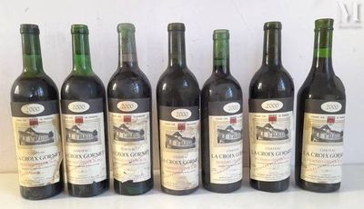 six bottles of wine are lined up in a row on a table
