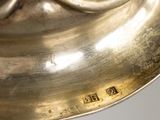 a close up of a silver plate with a clock on it