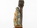 an image of a figurine of a man and a woman sitting under a tree