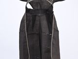 a black dress hanging on a hanger on a white wall