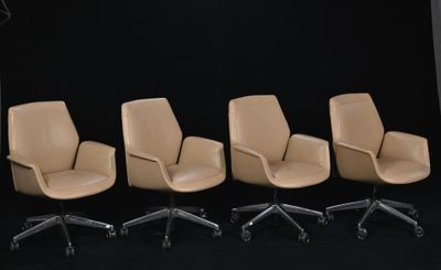 four office chairs are lined up in a row on a black background