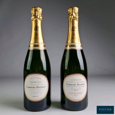 two bottles of champagne sitting next to each other on a table