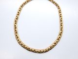 a gold chain bracelet on a white background
