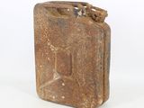 an old rusty metal canister sitting on top of a white surface