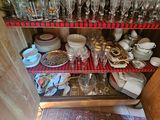 a cabinet with a lot of dishes and glasses on it