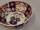 a small bowl with an orange and blue design on it
