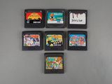 six video game cartridges sitting on top of a table