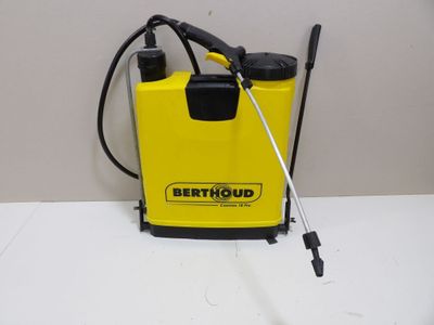 a yellow and black portable sprayer sitting on top of a white counter