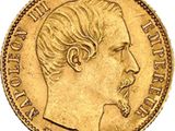 a close up of a gold coin with a profile of a man