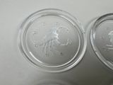 two clear glass containers with a picture of a man and a woman on them