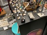 a table with a lot of jewelry on it in a store