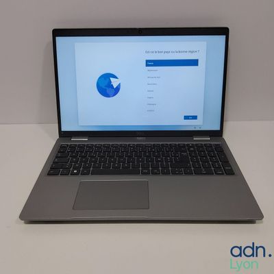 an open laptop computer sitting on top of a white table