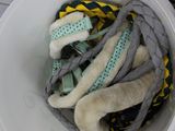 a bucket full of clothes sitting on the floor