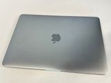 a silver apple laptop sitting on a white table