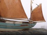 a model of a sailboat on display on a table