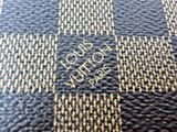 a close up of a brown and gold cross on a table