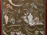 a picture of a wall hanging with a picture of birds and flowers on it