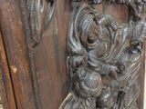 a wooden panel with carvings on it in a room