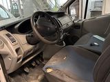 the interior of a car with the door open and the driver ' s seat down