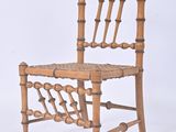 a wooden chair with a woven seat on a white background