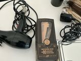 a hair dryer, a hair dryer, and other hair accessories on a table