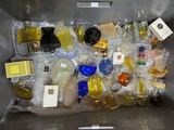 a metal container filled with bottles of perfume and other items