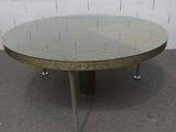 une image représentant une table ronde en verre avec des pieds en métal et un plateau en verre