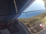 a reflection of a car on the side of the road