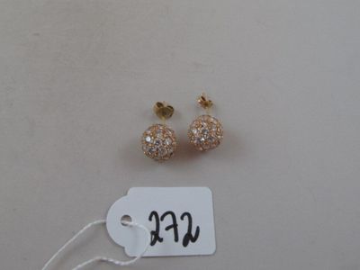 two pairs of earrings with a price tag on a white table