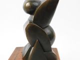 sculpture of a person sitting on a wooden block on a white background