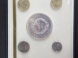 a picture of a picture of some coins in a box