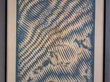 framed picture of a blue and white abstract painting on a wall