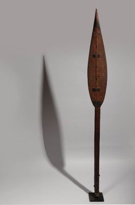 an old wooden paddle with a wooden handle on a white background